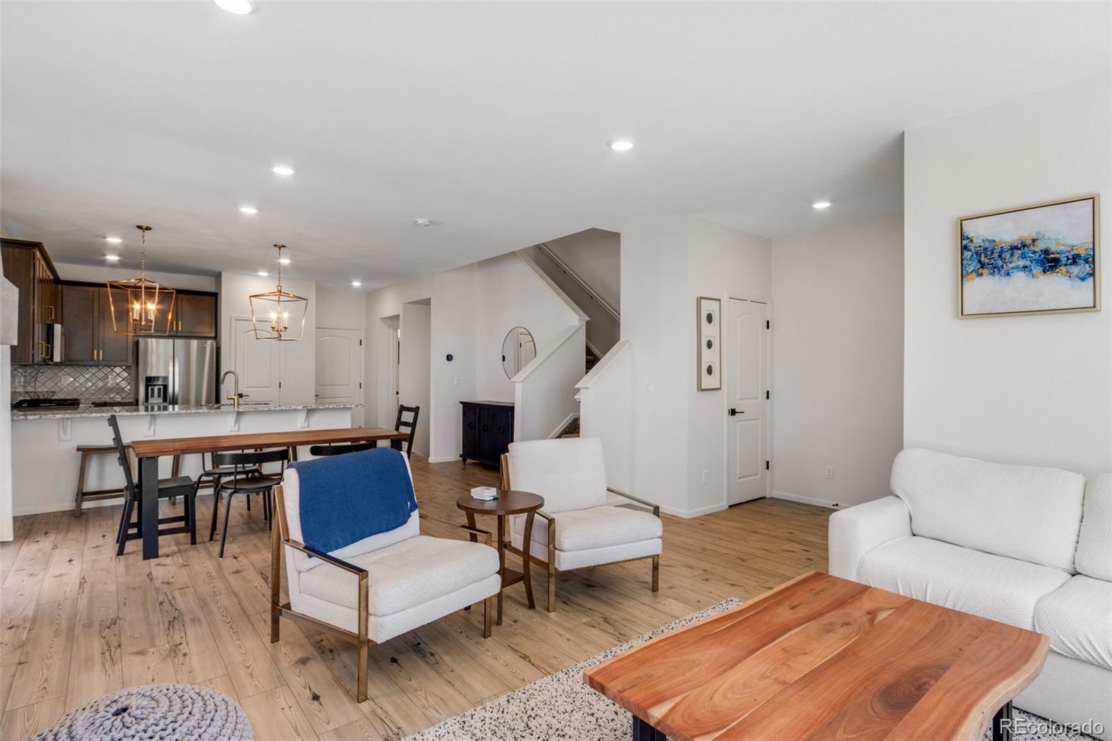 306 Rodden Drive Erie, CO 80516 - Photo 6 of 49 a living room with furniture and a wooden floor