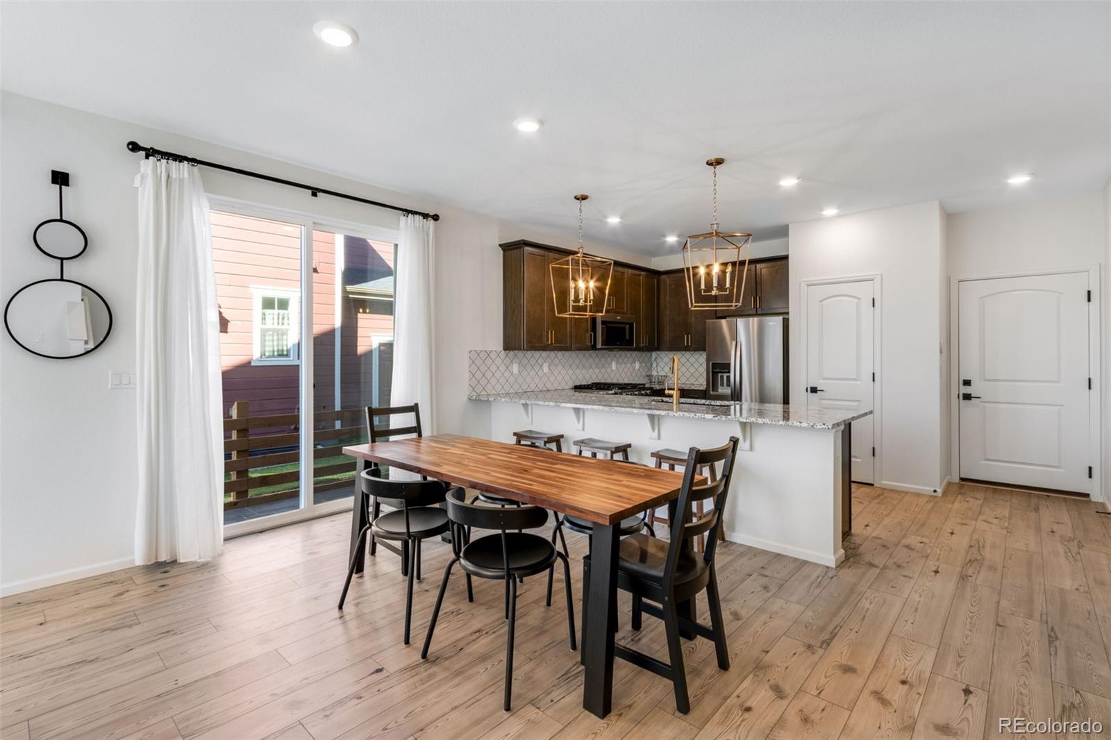306 Rodden Drive Erie, CO 80516 - Photo 8 of 49 a view of a dining room with furniture and wooden floor