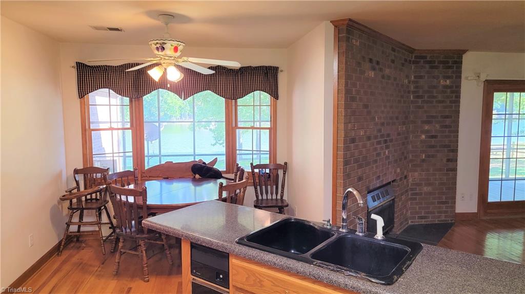 180 Roehm Landing Denton, NC 27239 - Photo 26 of 35 The refrigerator remains. From the sink there is a view of the lake.