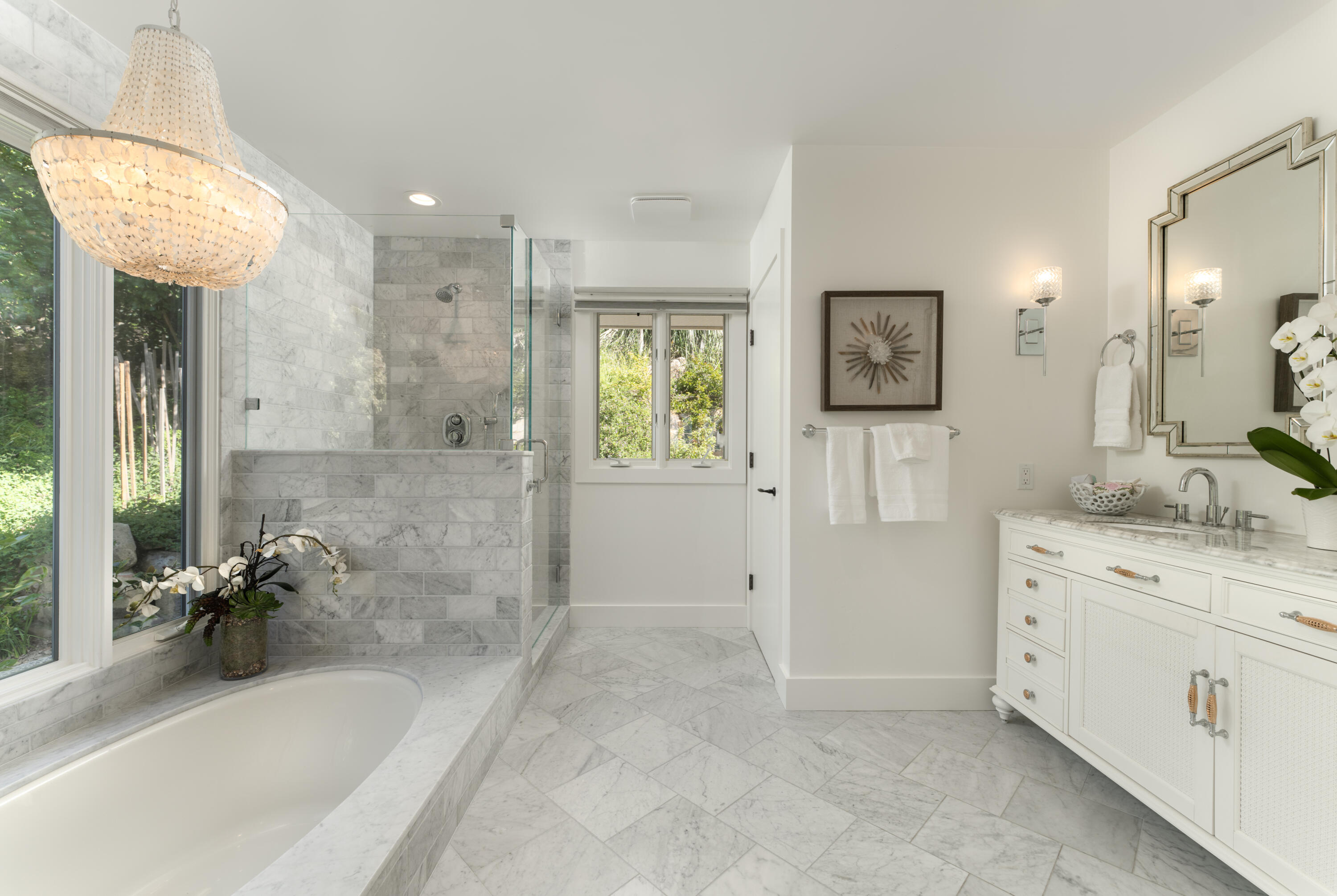 1568 Franceschi Road Santa Barbara, CA 93103 - Photo 7 of 17 a bathroom with a granite countertop sink a mirror a bathtub and shower