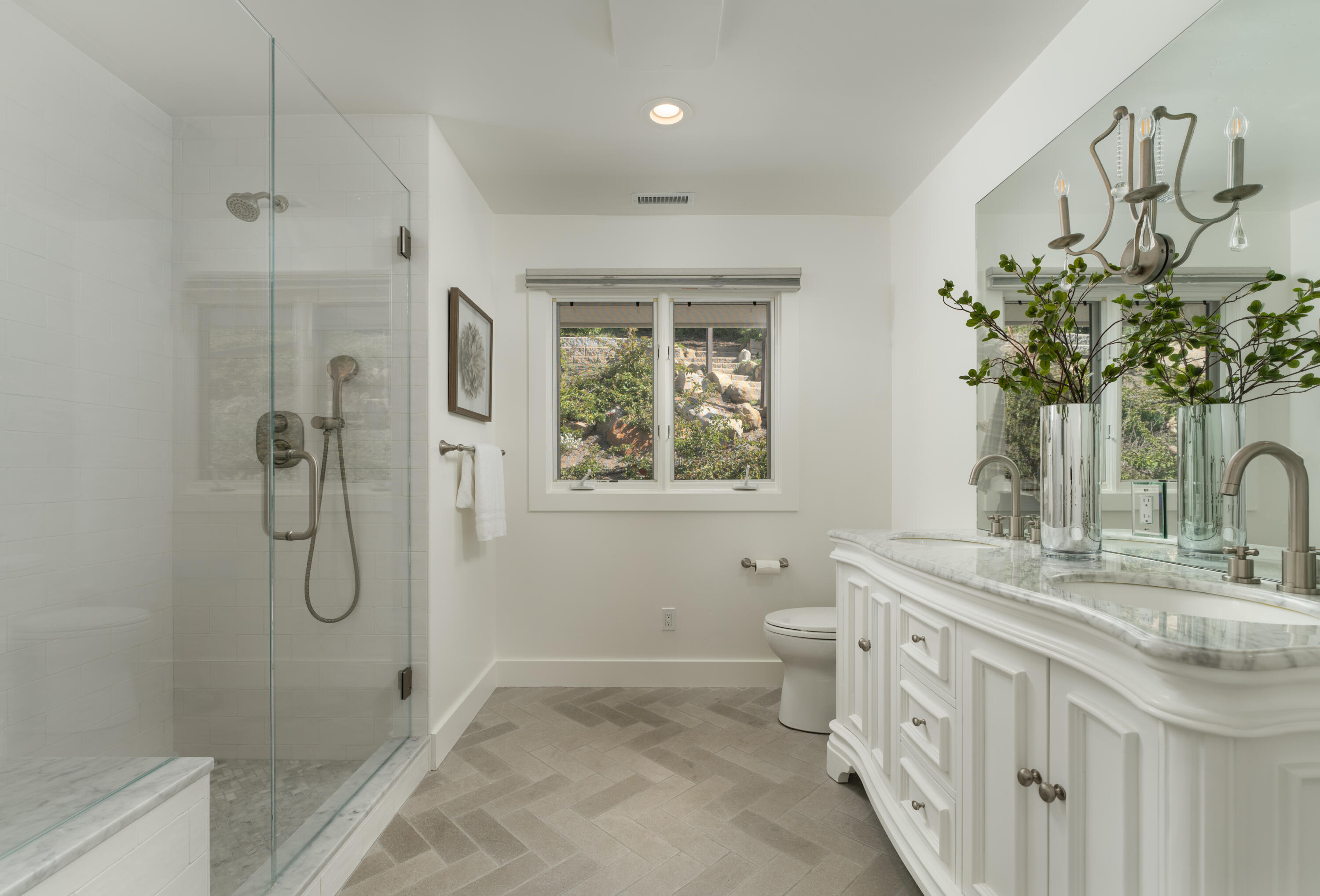 1568 Franceschi Road Santa Barbara, CA 93103 - Photo 9 of 17 a bathroom with a granite countertop sink a toilet and shower