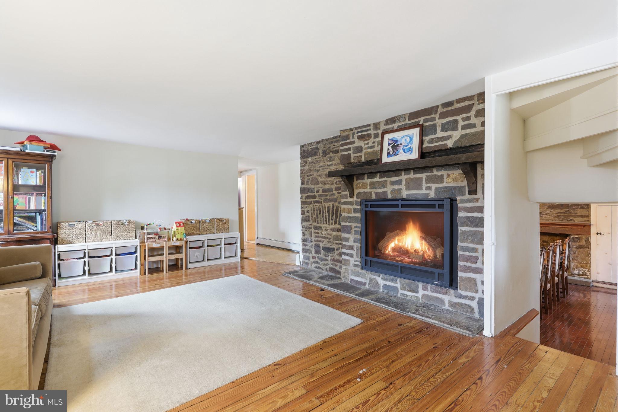 2293 Meetinghouse Road Jamison, PA 18929 - Photo 13 of 47 a living room with furniture a fireplace and a flat screen tv