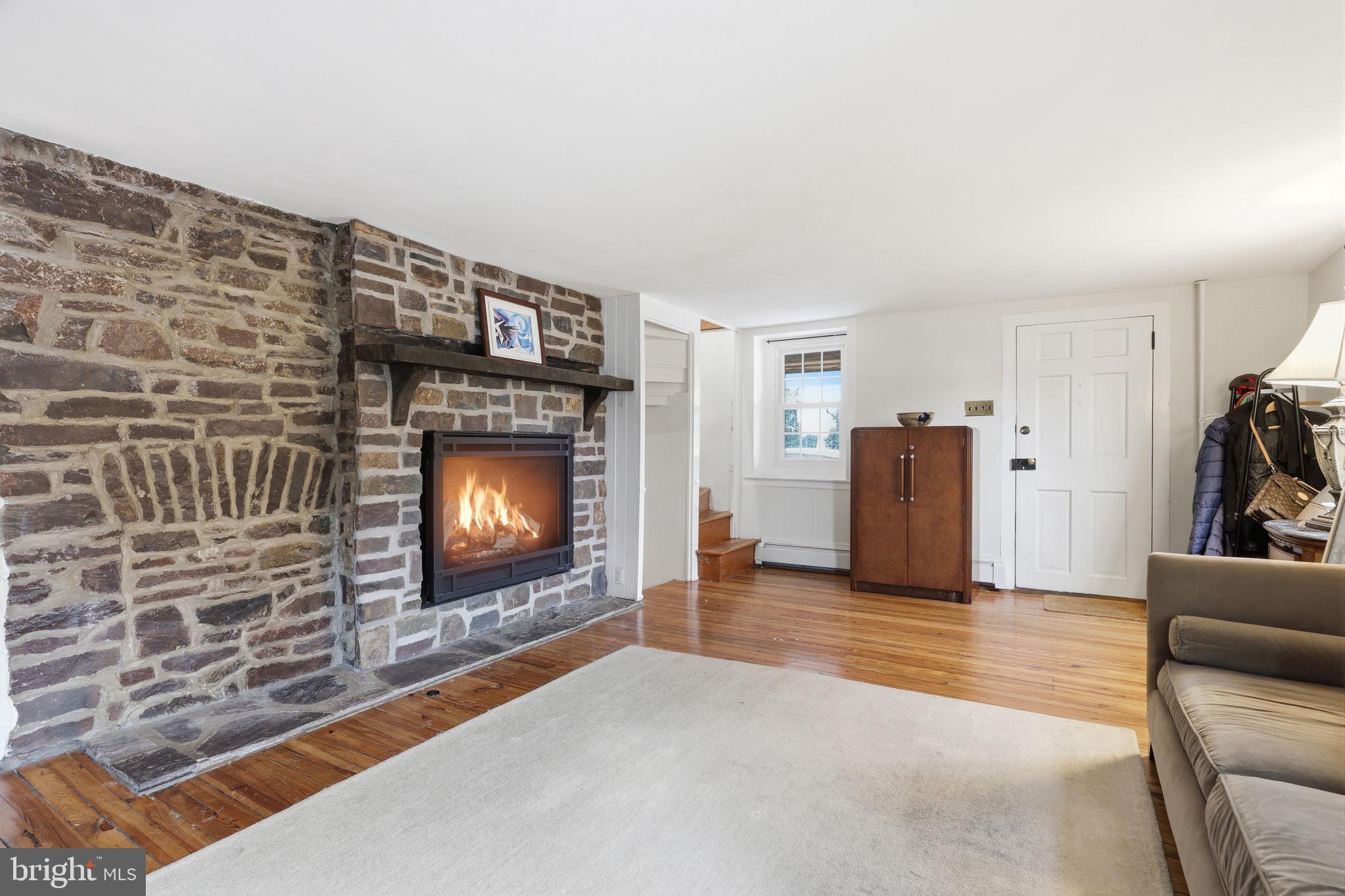 2293 Meetinghouse Road Jamison, PA 18929 - Photo 14 of 47 a living room with furniture a fireplace and a flat screen tv
