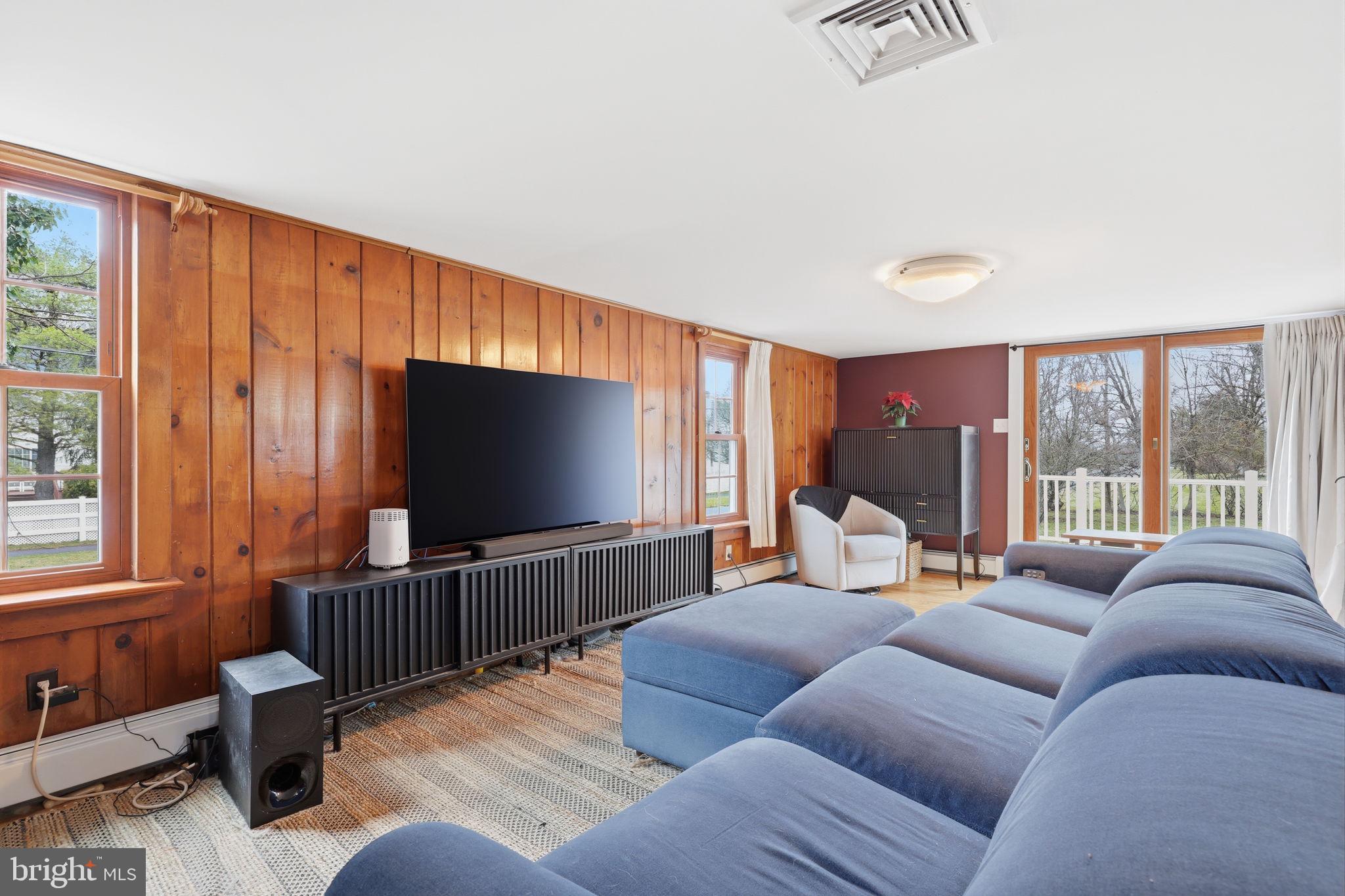 2293 Meetinghouse Road Jamison, PA 18929 - Photo 17 of 47 a living room with furniture a large window and a flat screen tv
