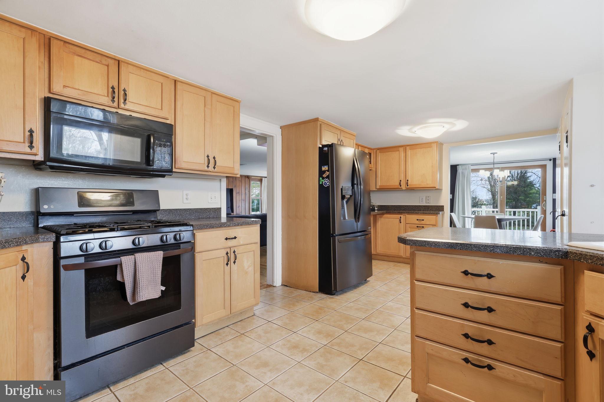 2293 Meetinghouse Road Jamison, PA 18929 - Photo 20 of 47 a kitchen with stainless steel appliances granite countertop a stove a refrigerator and a microwave