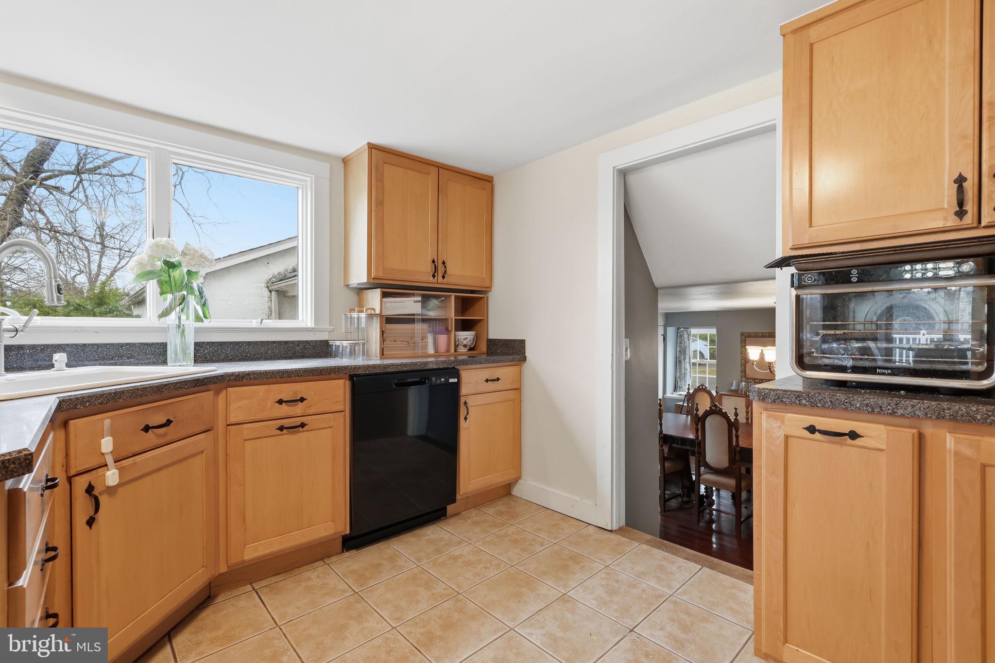 2293 Meetinghouse Road Jamison, PA 18929 - Photo 21 of 47 a kitchen with stainless steel appliances granite countertop a stove a sink and a refrigerator with wooden cabinets