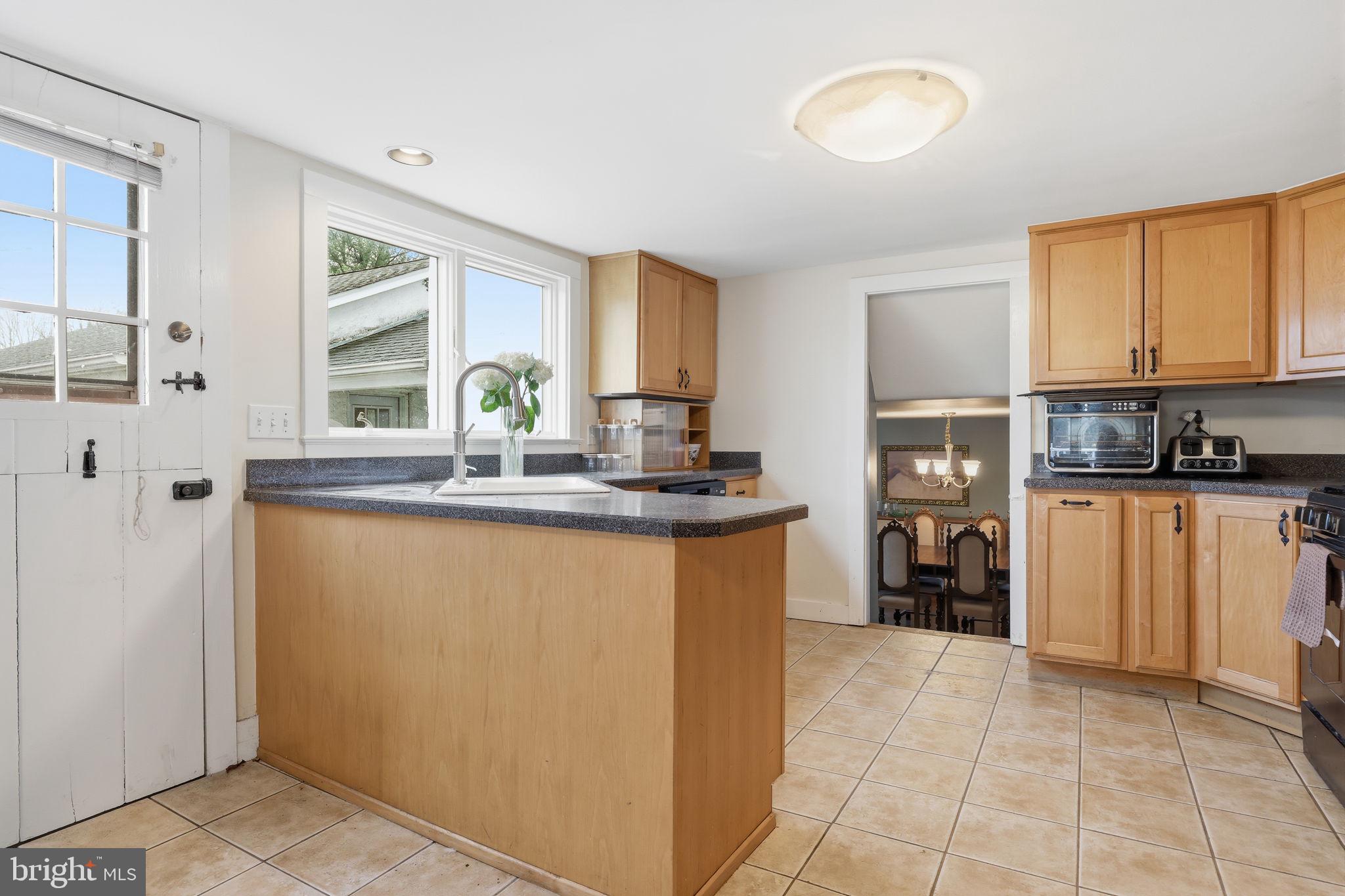 2293 Meetinghouse Road Jamison, PA 18929 - Photo 23 of 47 a kitchen with kitchen island granite countertop a refrigerator a stove a sink and a dishwasher with wooden cabinets