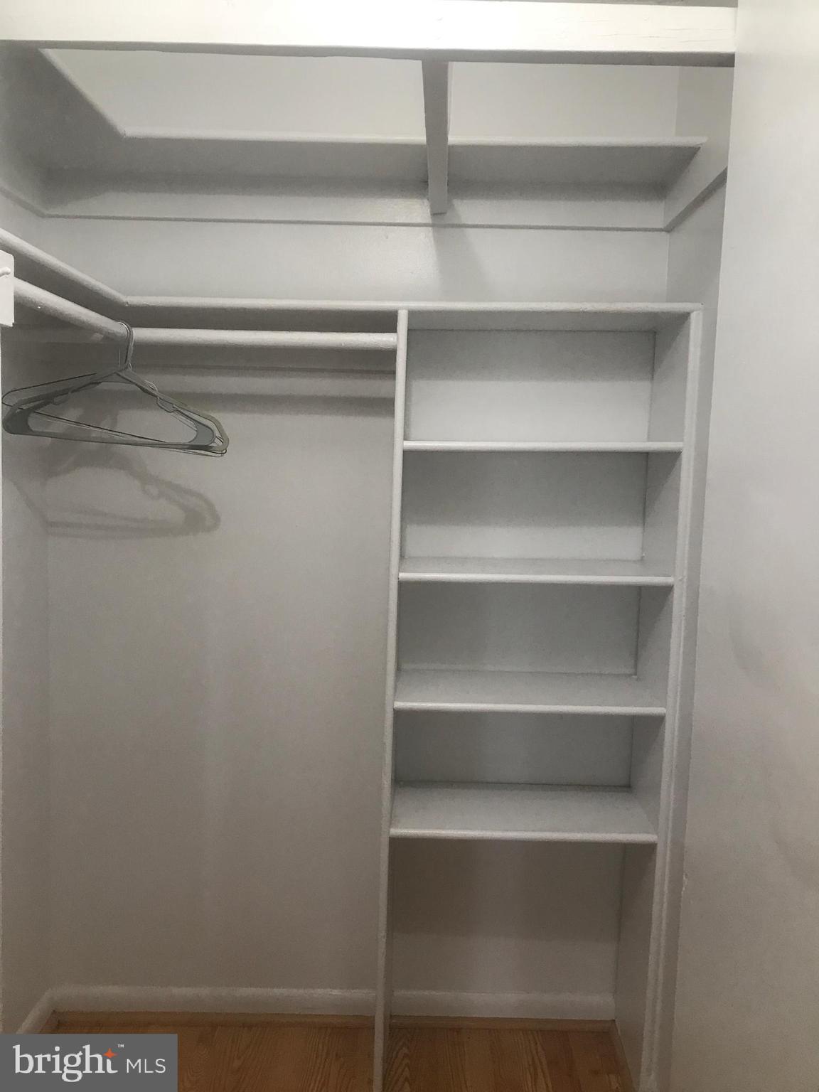 8830 Piney Branch Road Silver Spring, MD 20903 - Photo 2 of 15 a view of walk in closet with empty racks