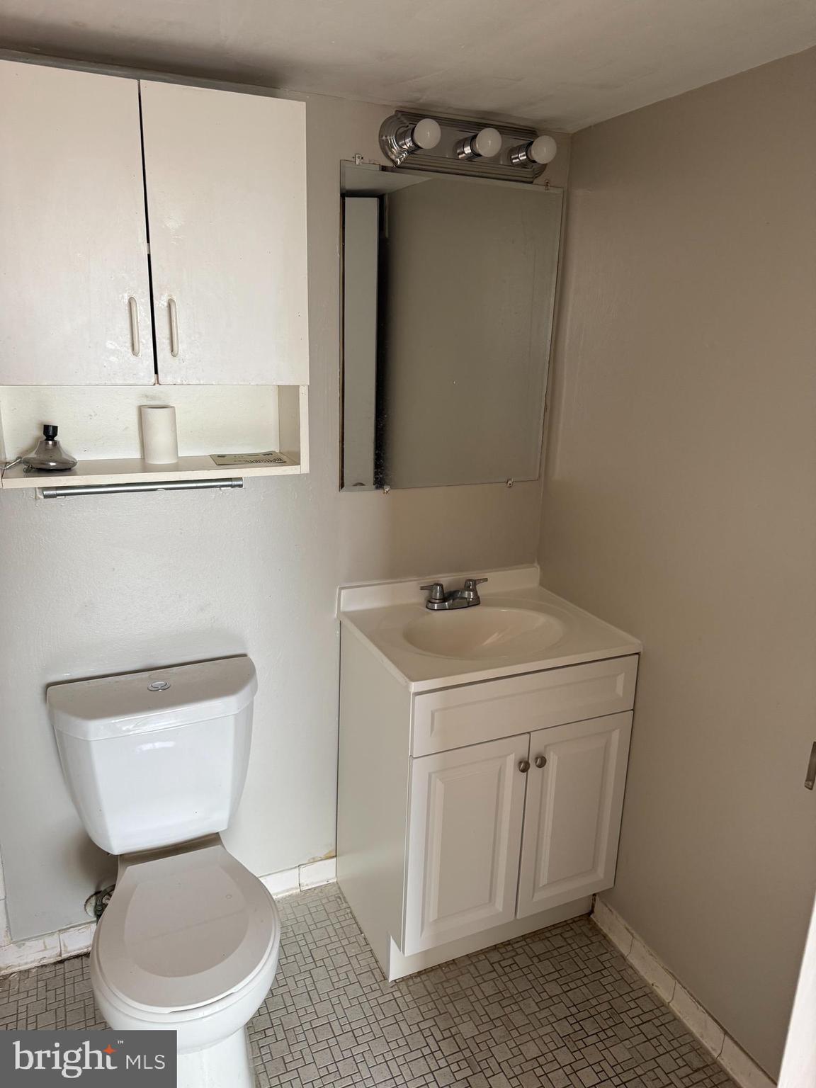 8830 Piney Branch Road Silver Spring, MD 20903 - Photo 9 of 15 a bathroom with a toilet sink and mirror