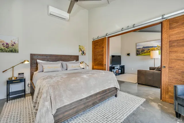 a living room with furniture kitchen and a large window