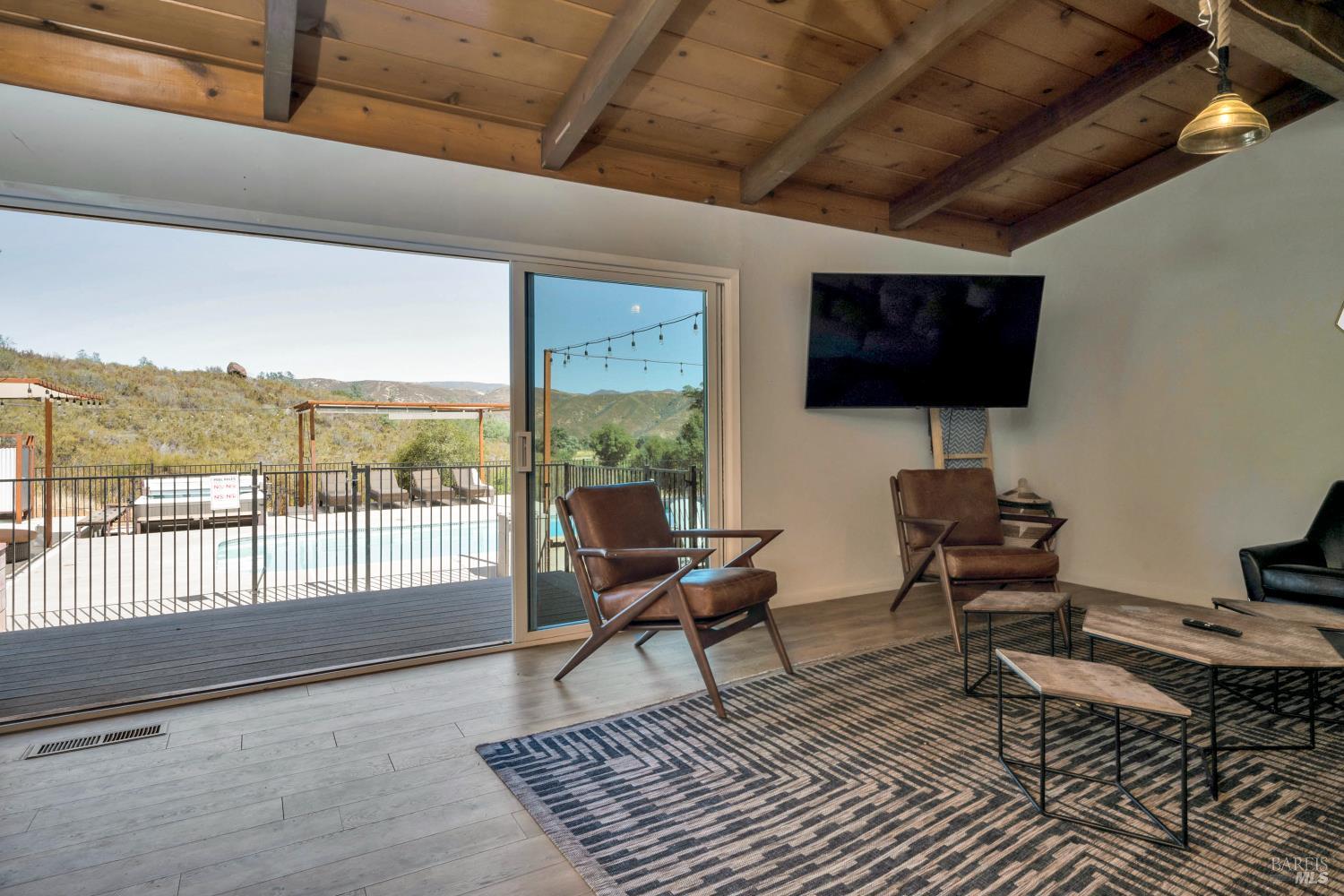 500 Old Long Valley Road Clearlake Oaks, CA 95423 - Photo 51 of 83 a living room with couches bookshelf and a flat screen tv