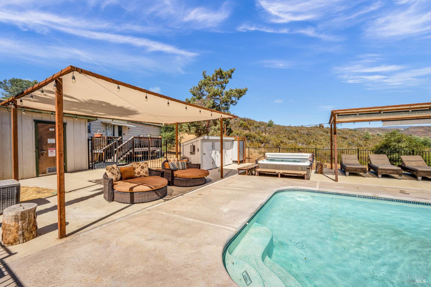 500 Old Long Valley Road Clearlake Oaks, CA 95423 - Photo 54 of 83 a view of a patio with table and chairs potted plants with wooden fence