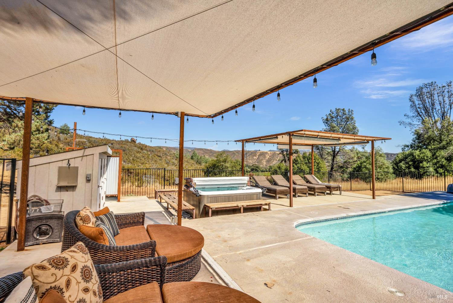 500 Old Long Valley Road Clearlake Oaks, CA 95423 - Photo 55 of 83 a view of a patio with a table and chairs under an umbrella