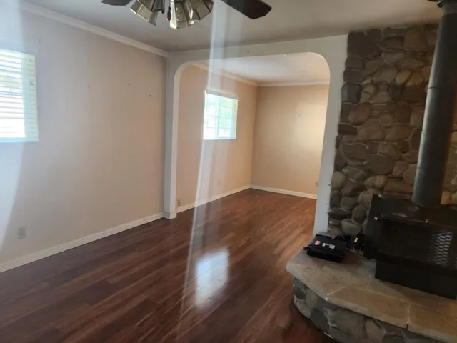 a view of a livingroom with wooden floor and a window