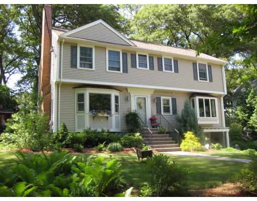 26 Tomahawk Road Arlington, MA 02474 - Photo 3 of 30 a front view of a house with a yard and potted plants