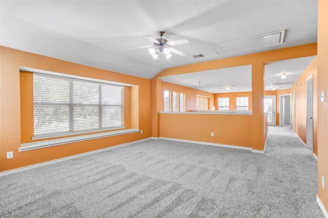 a view of a kitchen with wooden floor and a window