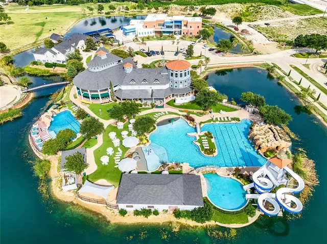 a aerial view of a house with yard swimming pool and outdoor seating