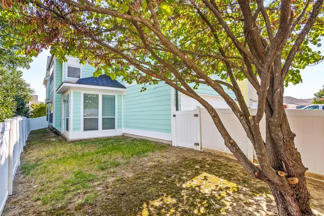 an aerial view of a residential houses with outdoor space