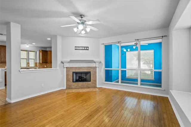 a living room with furniture fireplace and a large window