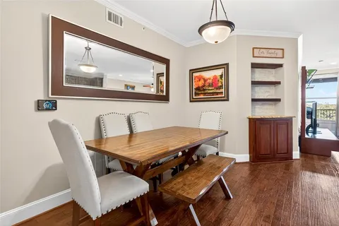 a dining room with furniture and wooden floor