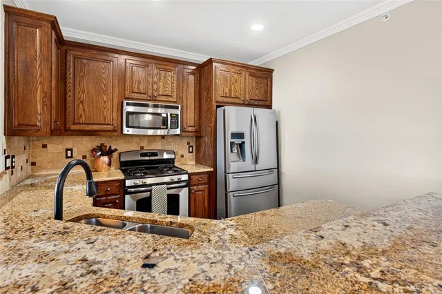 a kitchen with a refrigerator stove and sink