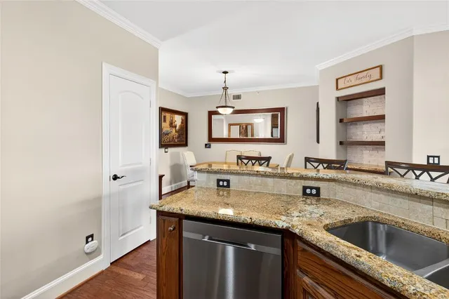 a kitchen with granite countertop a sink and a stove