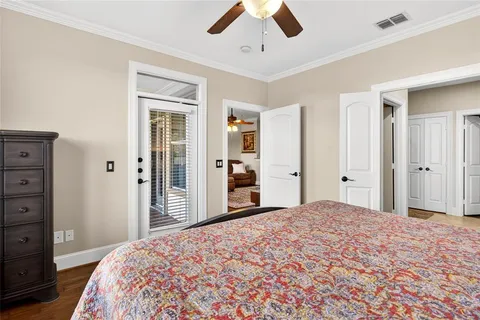 a bedroom with a large bed and chandelier