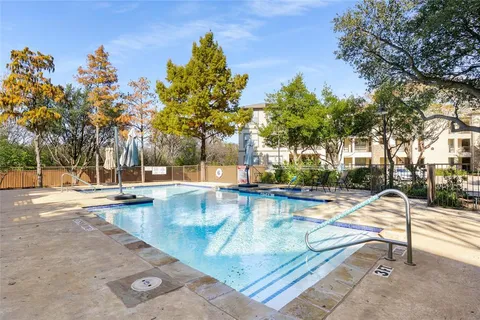 a view of a swimming pool with a lounge chair