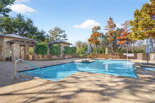 a view of yard with swimming pool and sitting area