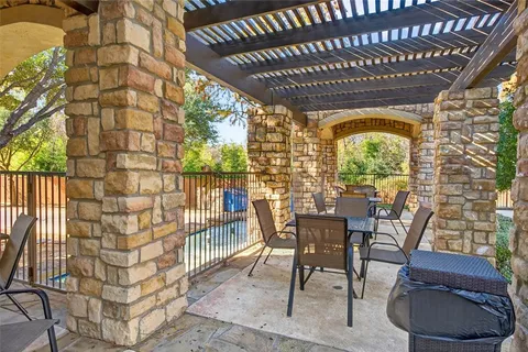 a view of a porch with furniture and garden