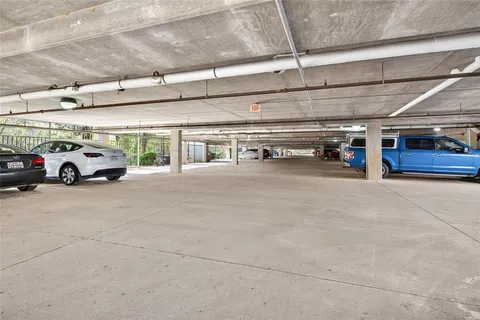 a view of parking garage with cars