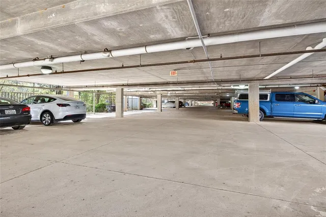 a view of parking garage with cars