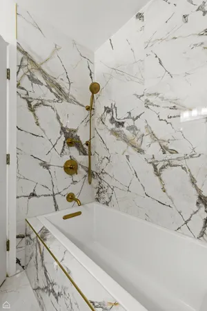 a bathroom with a bathtub and shower