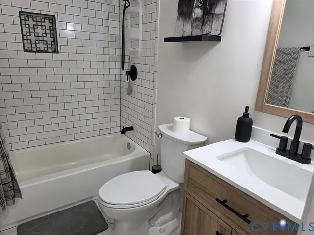 a bathroom with a sink a toilet and bathtub