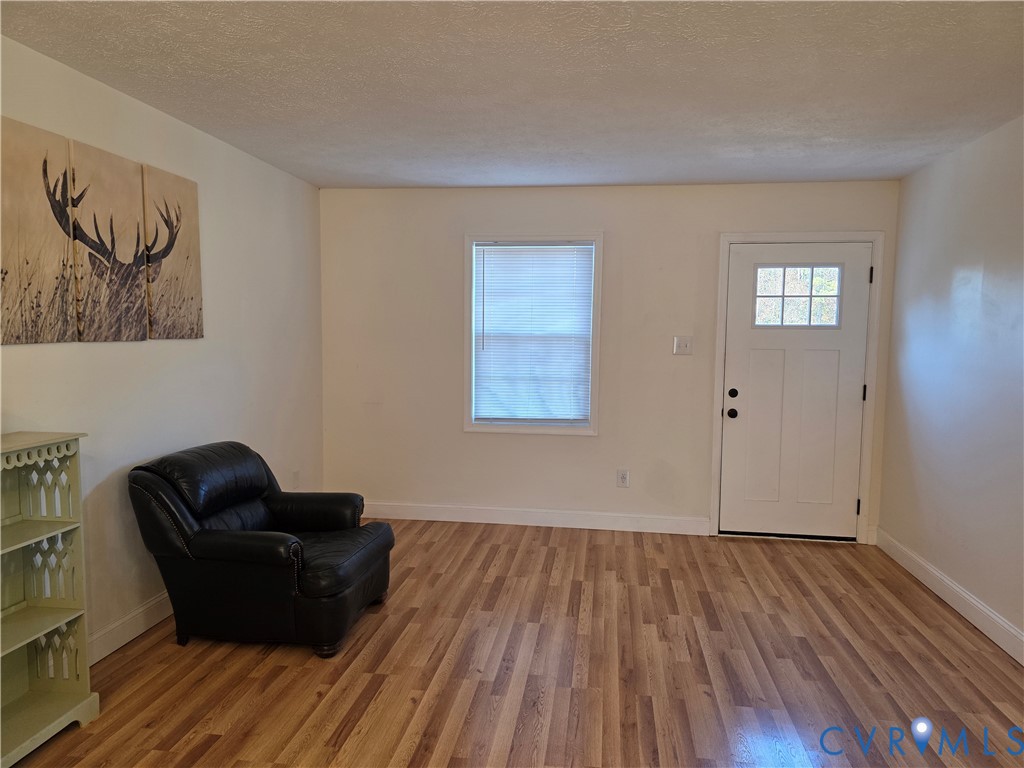 11782 Mt Landing Road Tappahannock, VA 22560 - Photo 3 of 15 a living room with furniture and a wooden floor