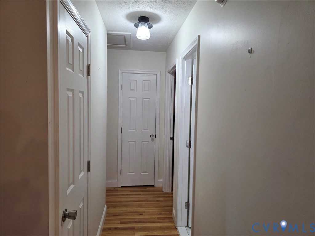 11782 Mt Landing Road Tappahannock, VA 22560 - Photo 7 of 15 a view of a hallway with wooden floor and staircase
