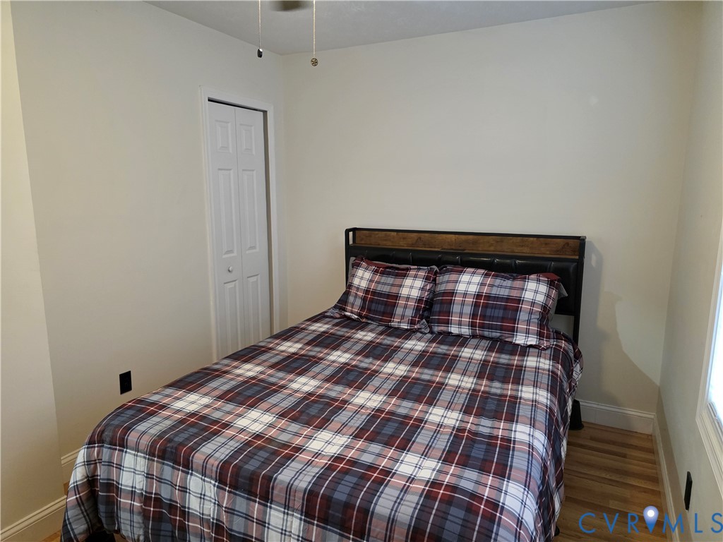 11782 Mt Landing Road Tappahannock, VA 22560 - Photo 8 of 15 a bedroom with a bed and a mirror