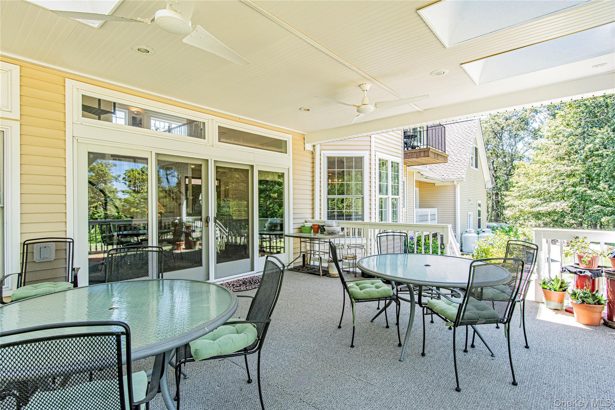 291 Woodmont Road Hopewell Junction, NY 12533 - Photo 13 of 49 a dining room with furniture large windows and wooden floor