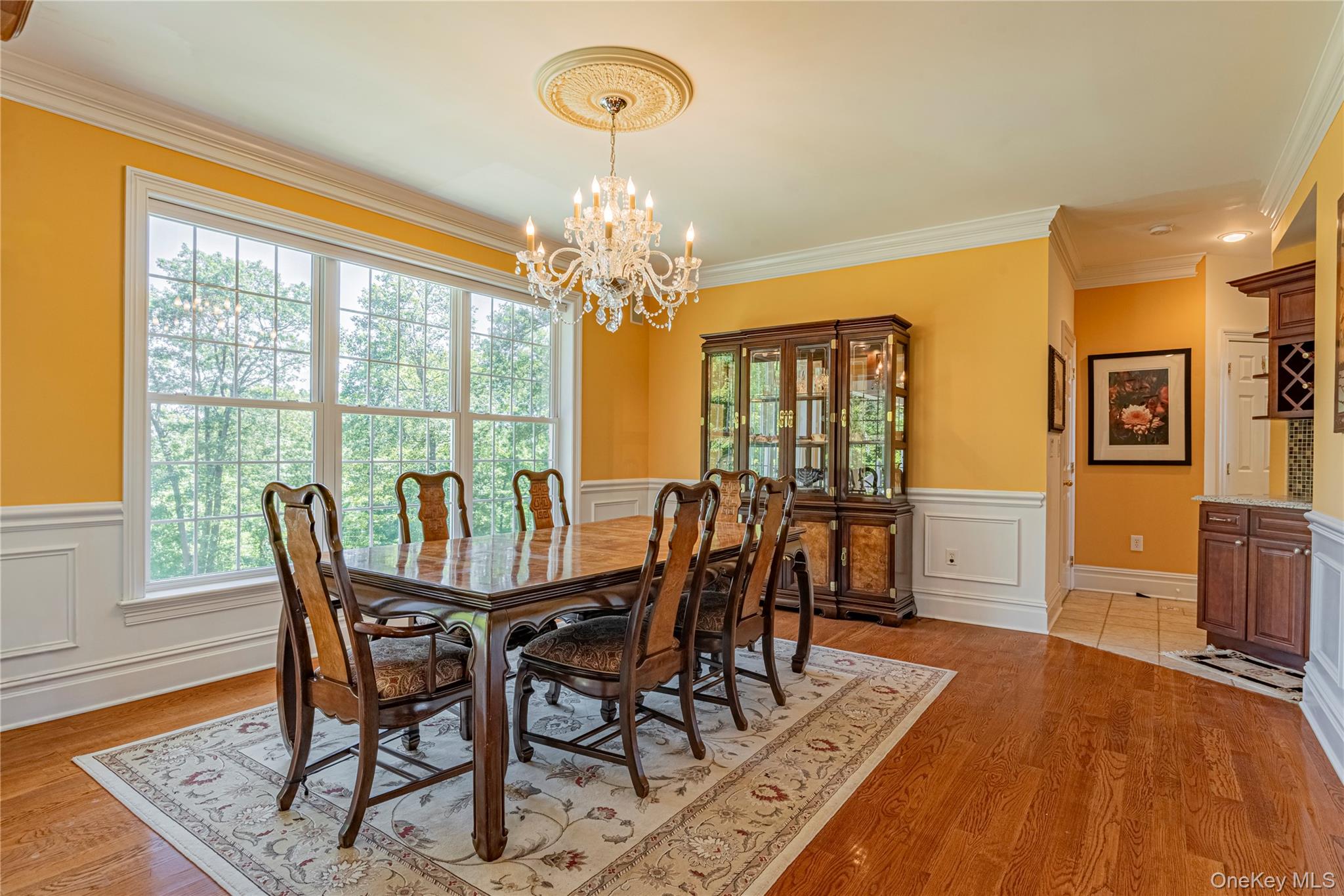 291 Woodmont Road Hopewell Junction, NY 12533 - Photo 16 of 49 a dining room with furniture a chandelier and wooden floor