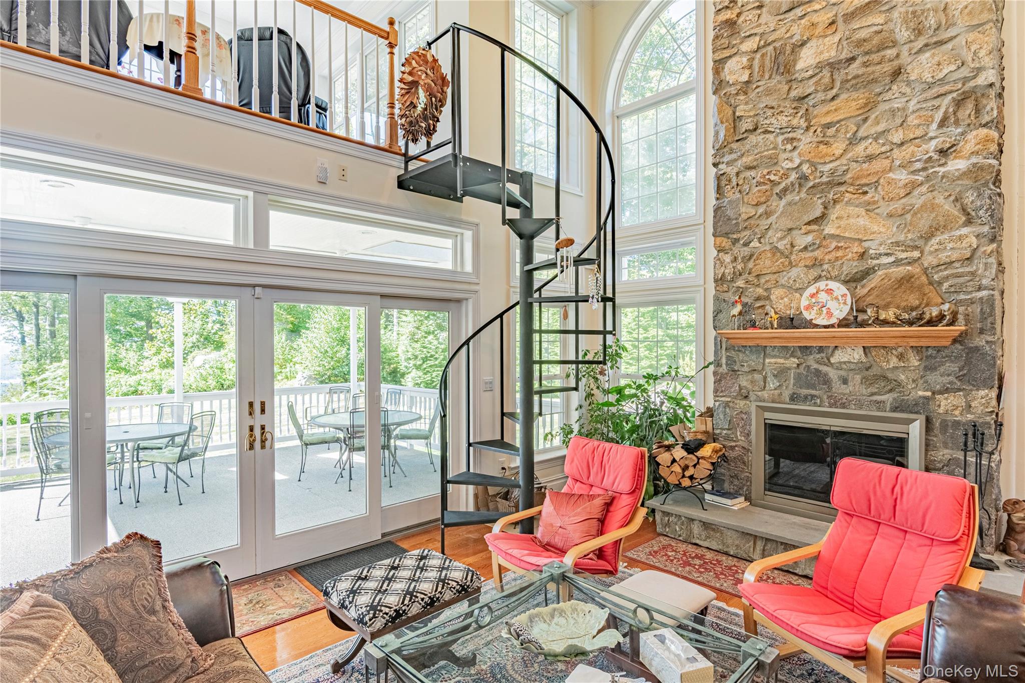 291 Woodmont Road Hopewell Junction, NY 12533 - Photo 32 of 49 a living room with furniture a fireplace and a floor to ceiling window