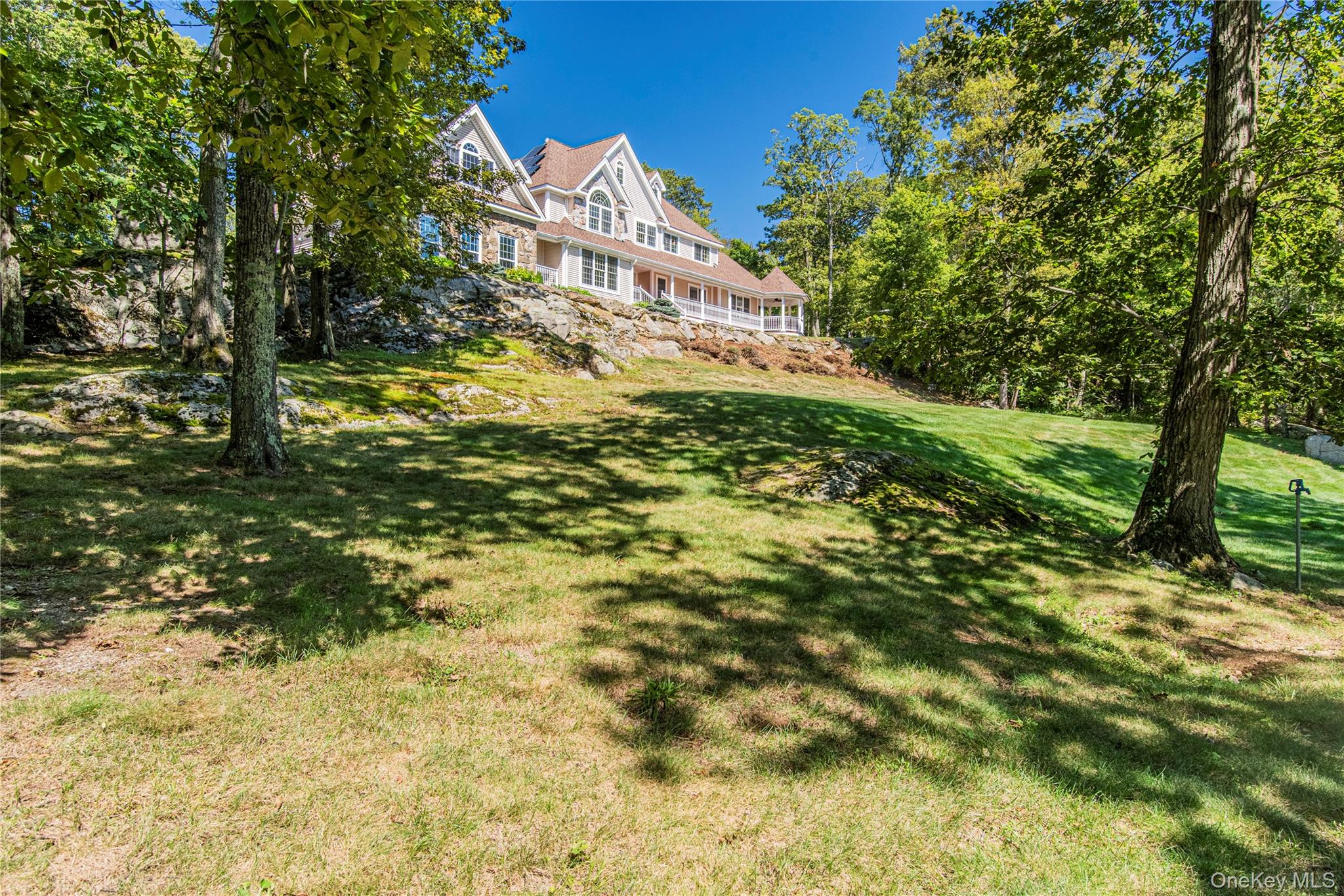 291 Woodmont Road Hopewell Junction, NY 12533 - Photo 5 of 49 a view of a yard with plants and large trees