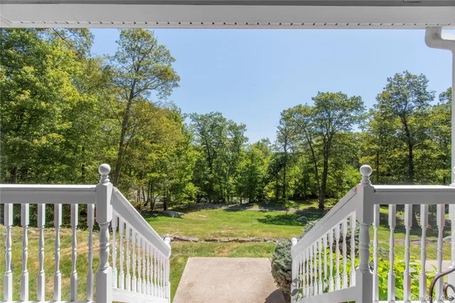 a view of a house with a yard and balcony