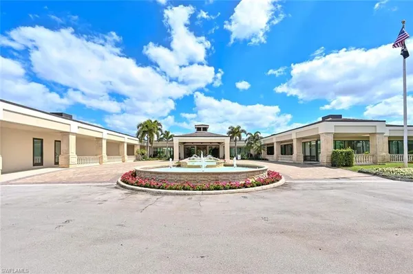 a view of a house with pool and chairs