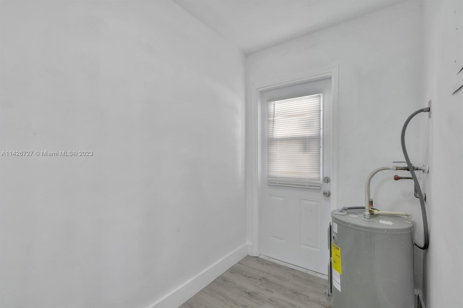 4964 Northwest 48th Way Tamarac, FL 33319 - Photo 13 of 16 a bathroom with a sink and washing machine