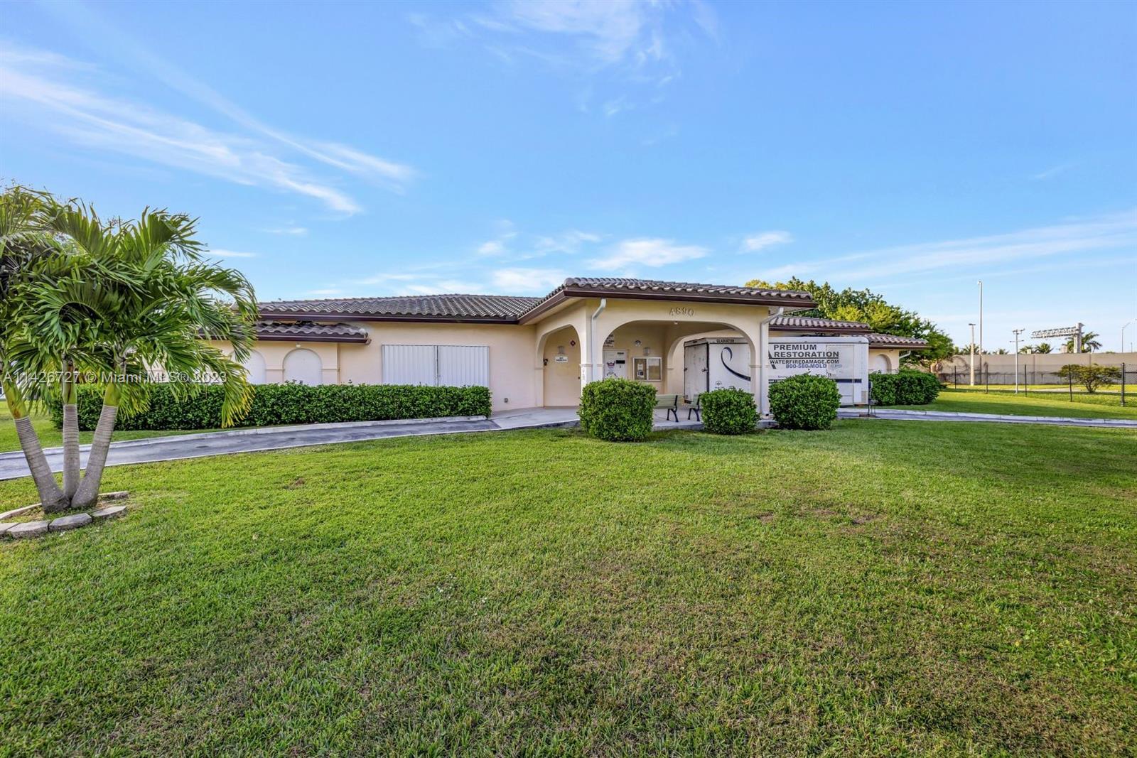 4964 Northwest 48th Way Tamarac, FL 33319 - Photo 15 of 16 a view of a house with backyard and garden