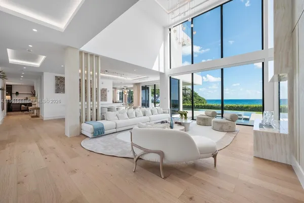 a view of a livingroom with furniture and large windows