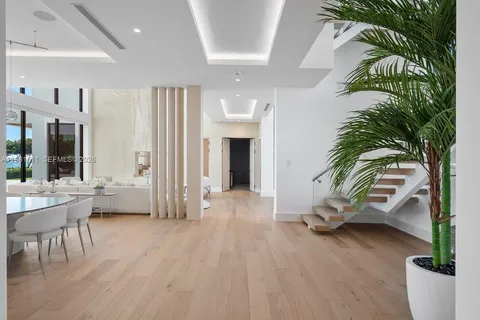a living room with furniture a rug and a large window