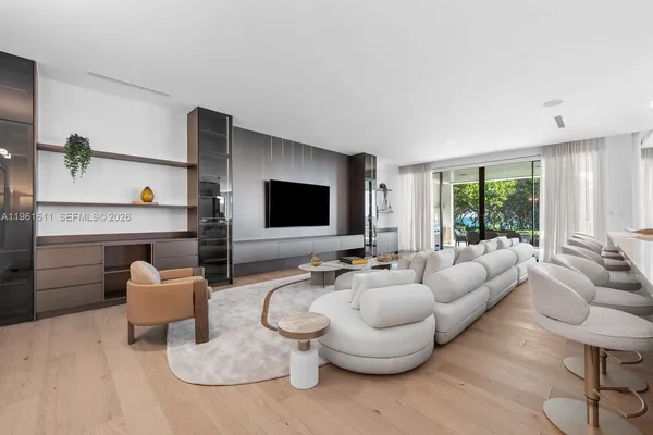 a kitchen with stainless steel appliances kitchen island granite countertop a refrigerator and a sink