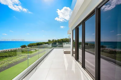 a view of a patio with table and chairs with plants and garden