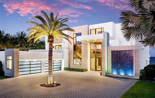 a view of a large building with a big yard and large trees